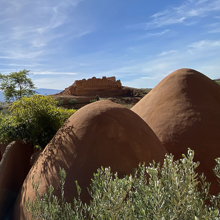 Eco-domes in the foreground and a moroccan kasbah in the background